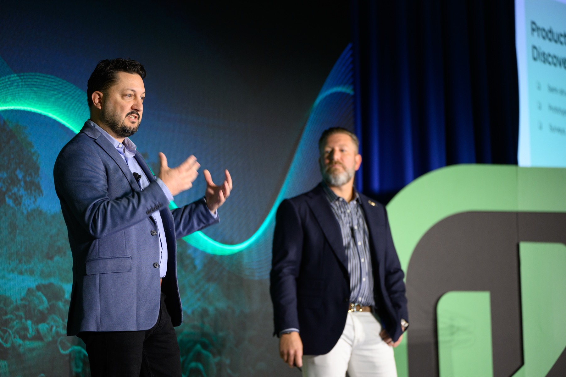 Jake presenting on stage alongside Rentvine's President